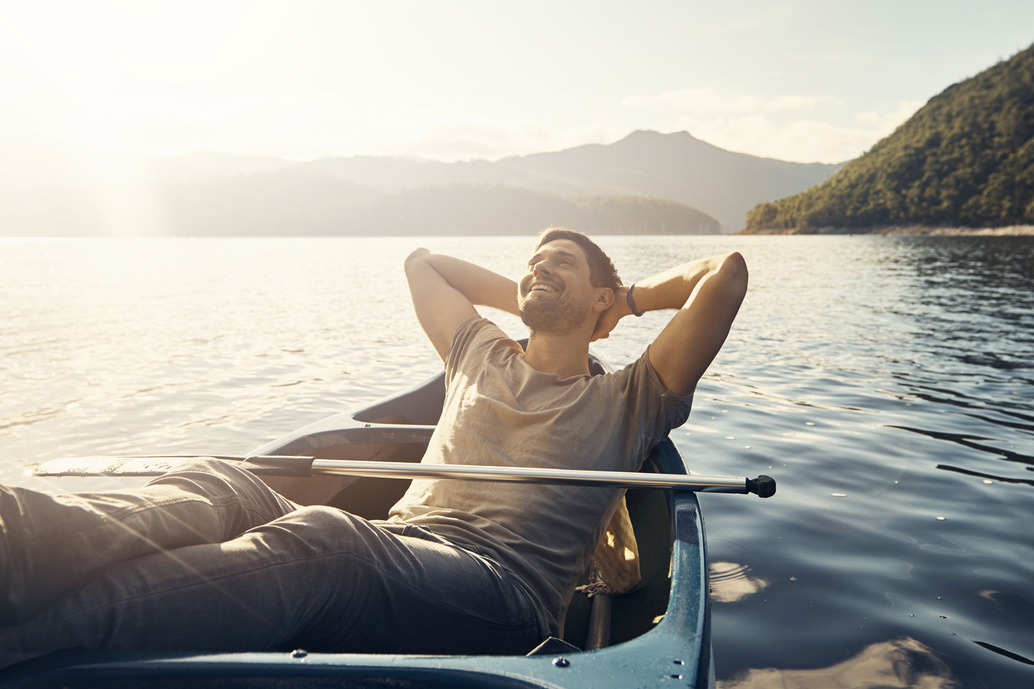 a man relaxes in his boat on a lake