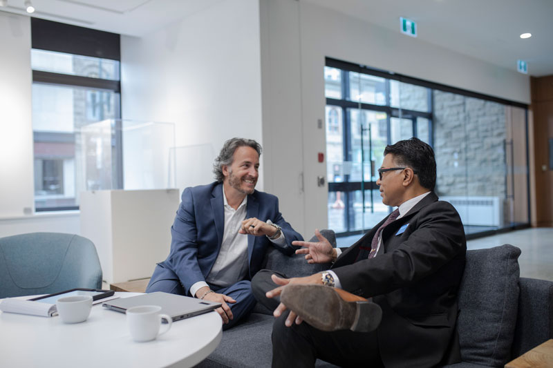 Two men talking in a lounge area