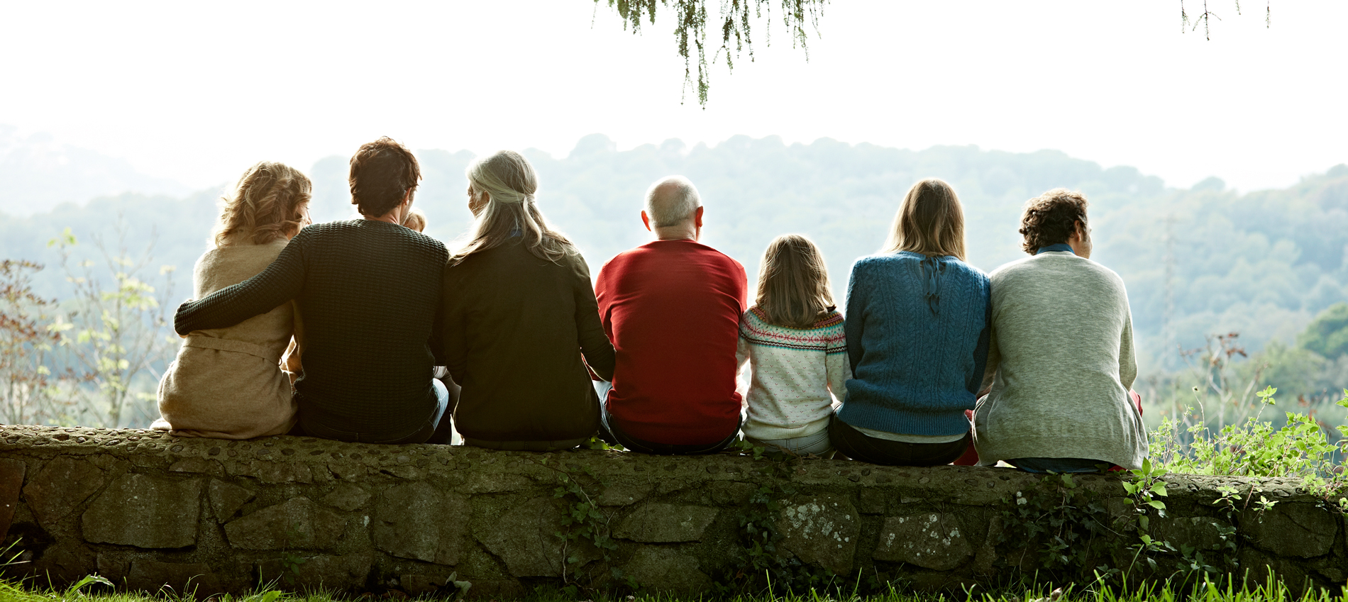 Family sitting on a hillside