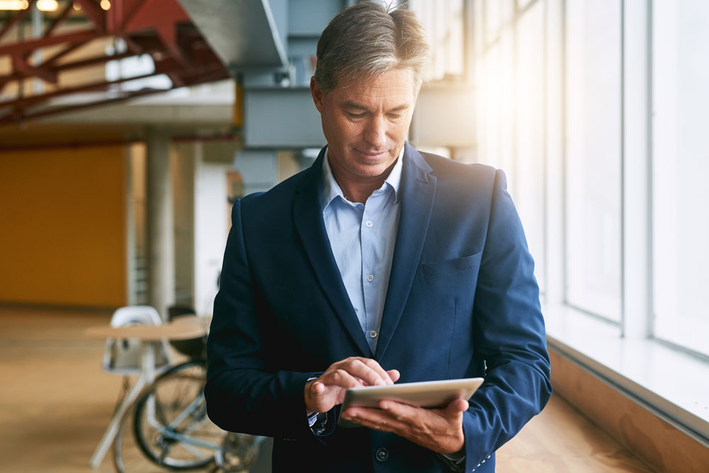 Business man checking his mobile tablet