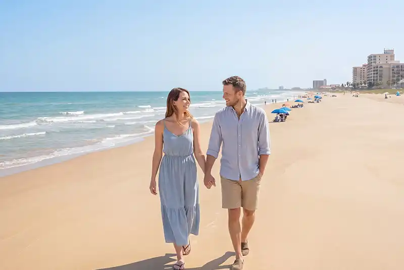 a couple visits the beach on their dream vacation