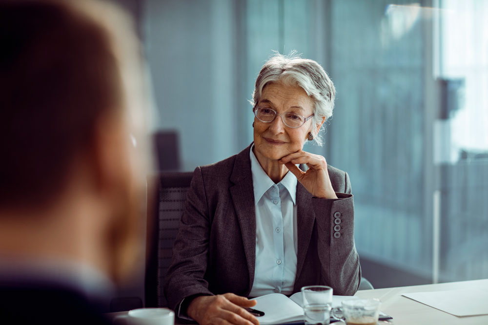 Elderly woman looking at someone smilling