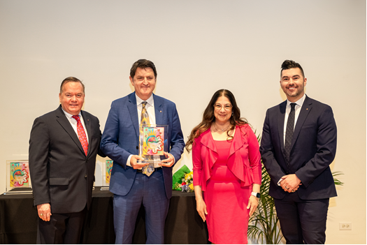 Four people holding award and smiling