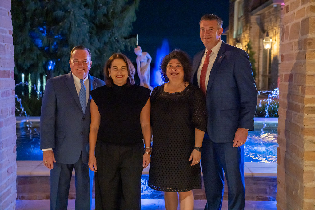 four people standing together