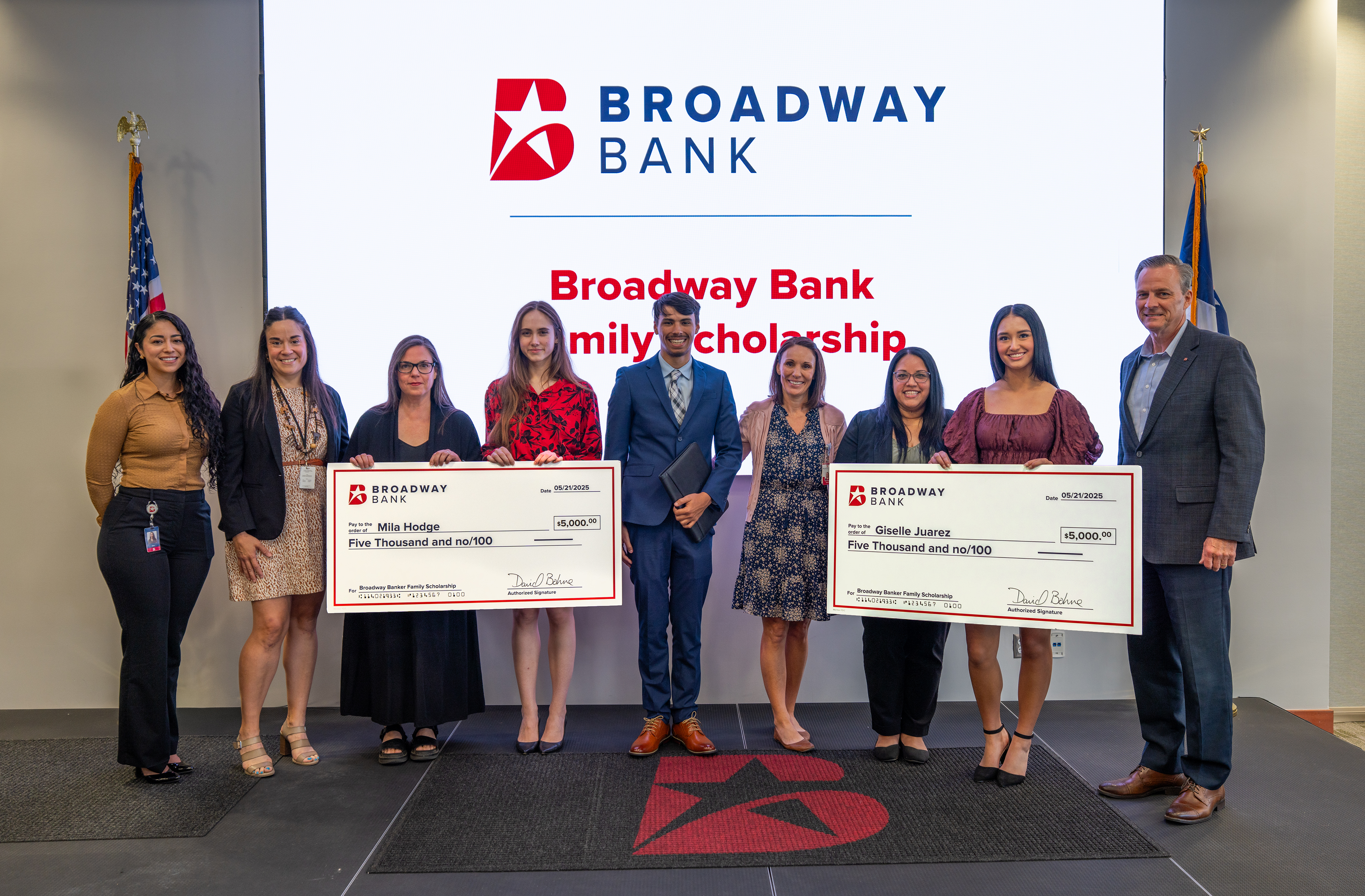 group of people holding scholarship checks