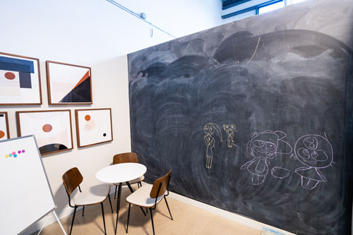 Friends of the children office space that has a black chalkboard, small table and small chairs