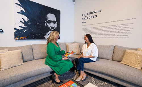 Two women sitting on a couch talking