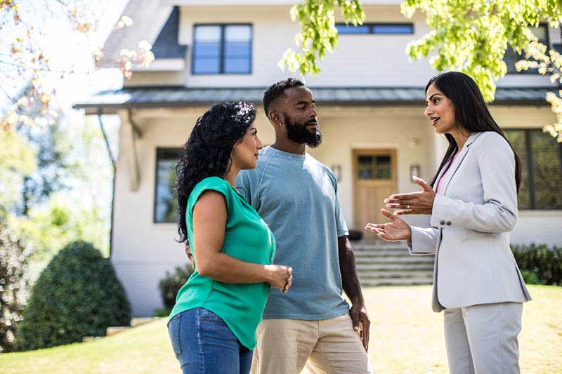 Couple talking with a realtor