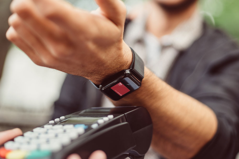 Man using his Apple watch to pay at store