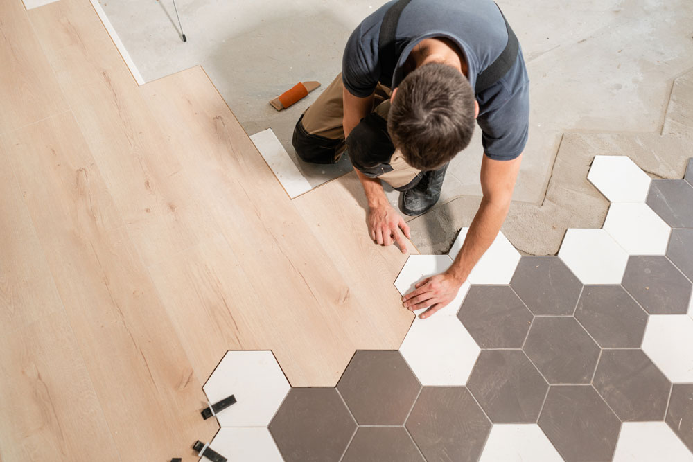 Contractor putting tiles on the floors