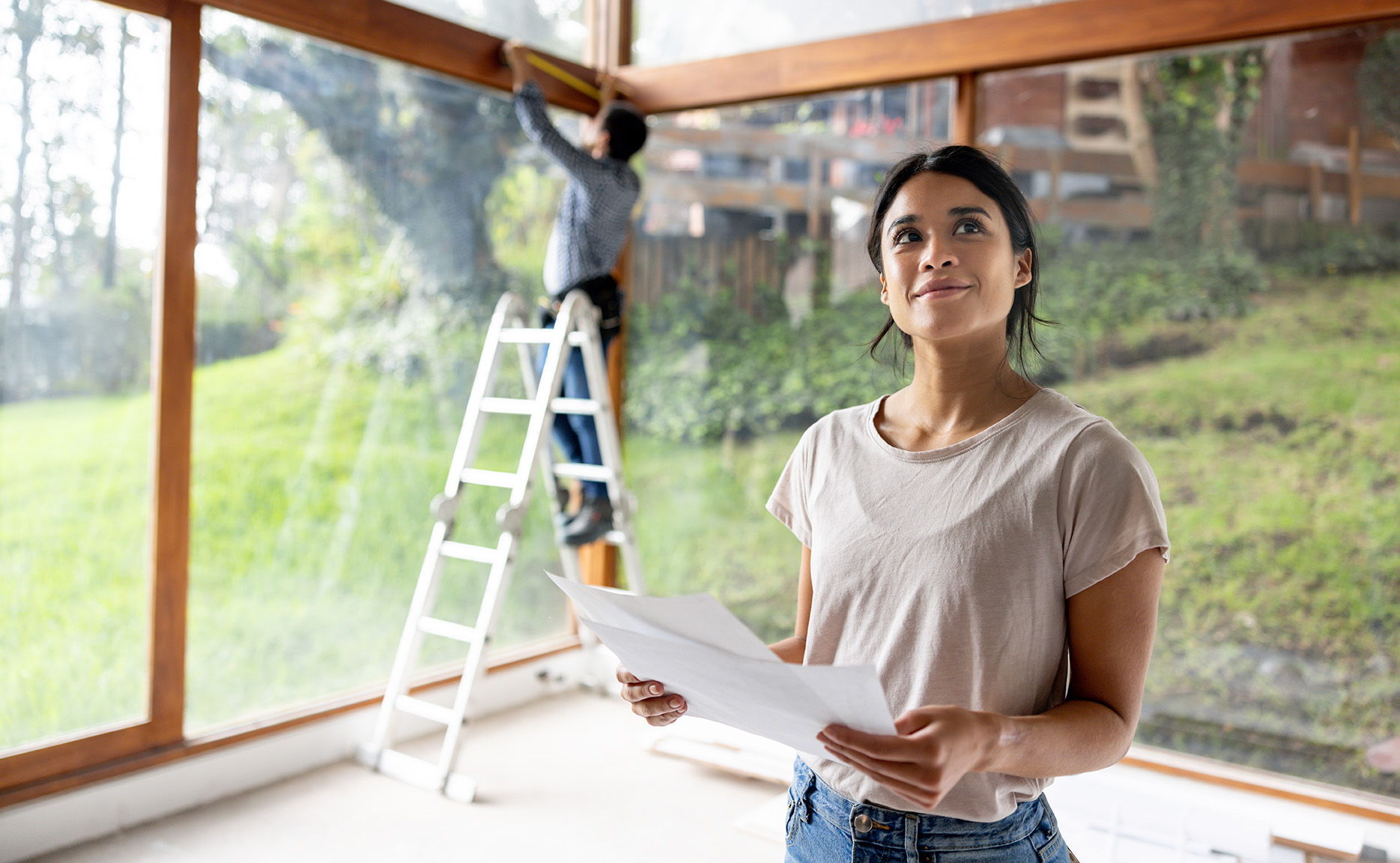 a woman looks at the patio she is building