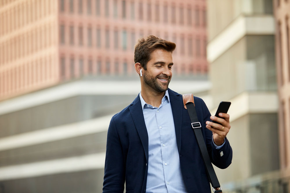 Man walking in the city looking at his phone