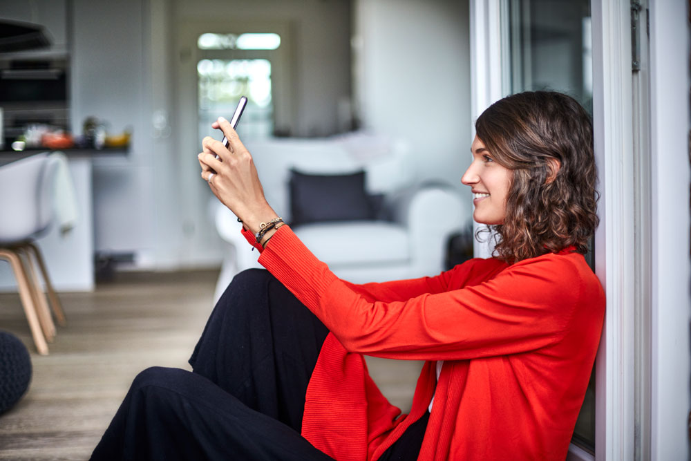 Young woman checking her cell phone