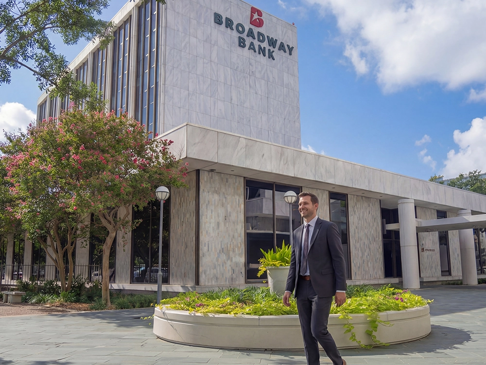 A man walking in the courtyard at Broadway Bank main financial center