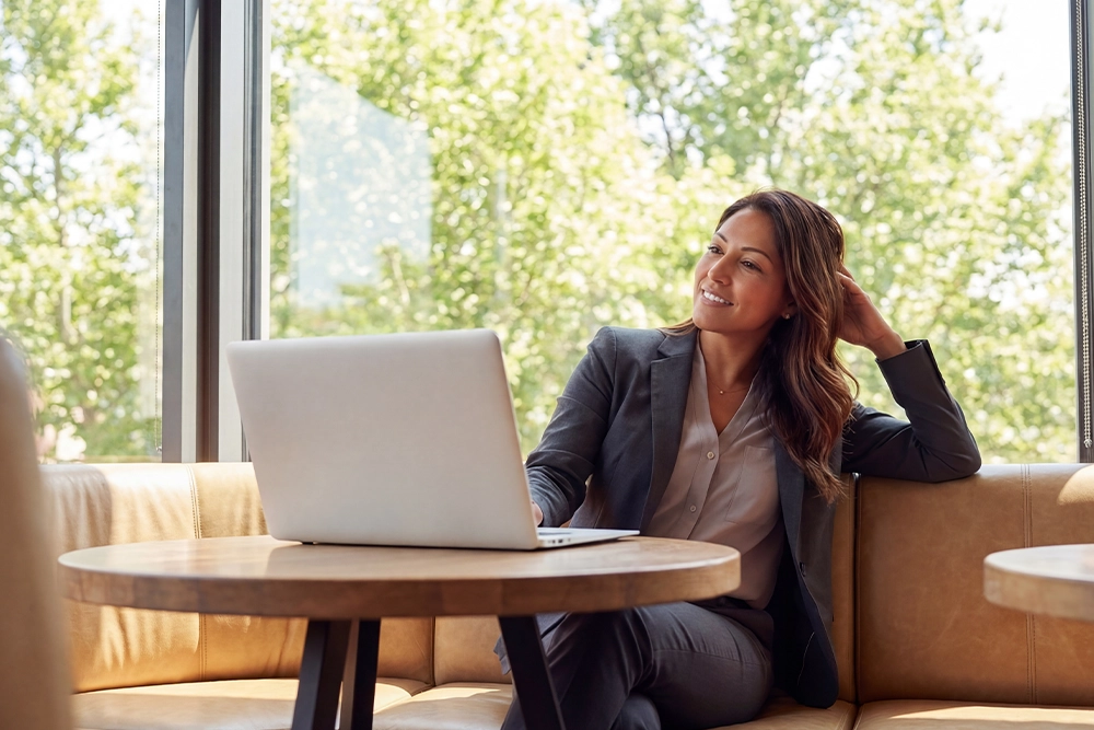 A business woman sitting with laptop on a table