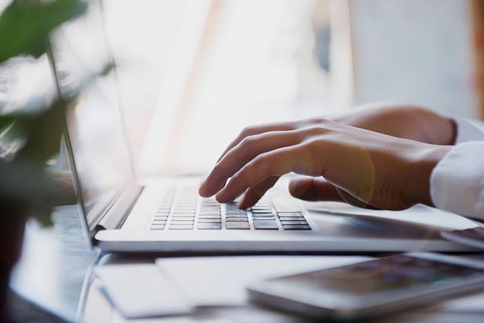 Person typing on a laptop