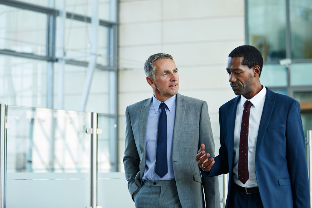two business professionals walking and talking