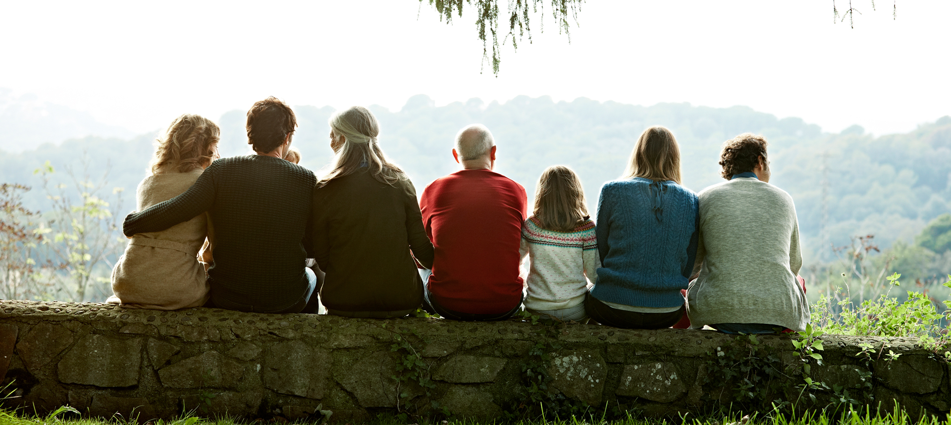 A family sitting overlooking hills