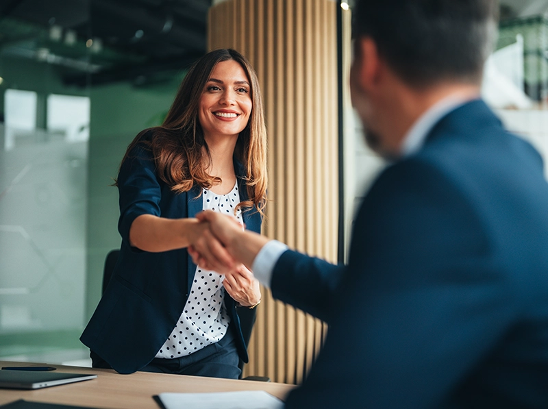 woman shaking shaking hands with a banker