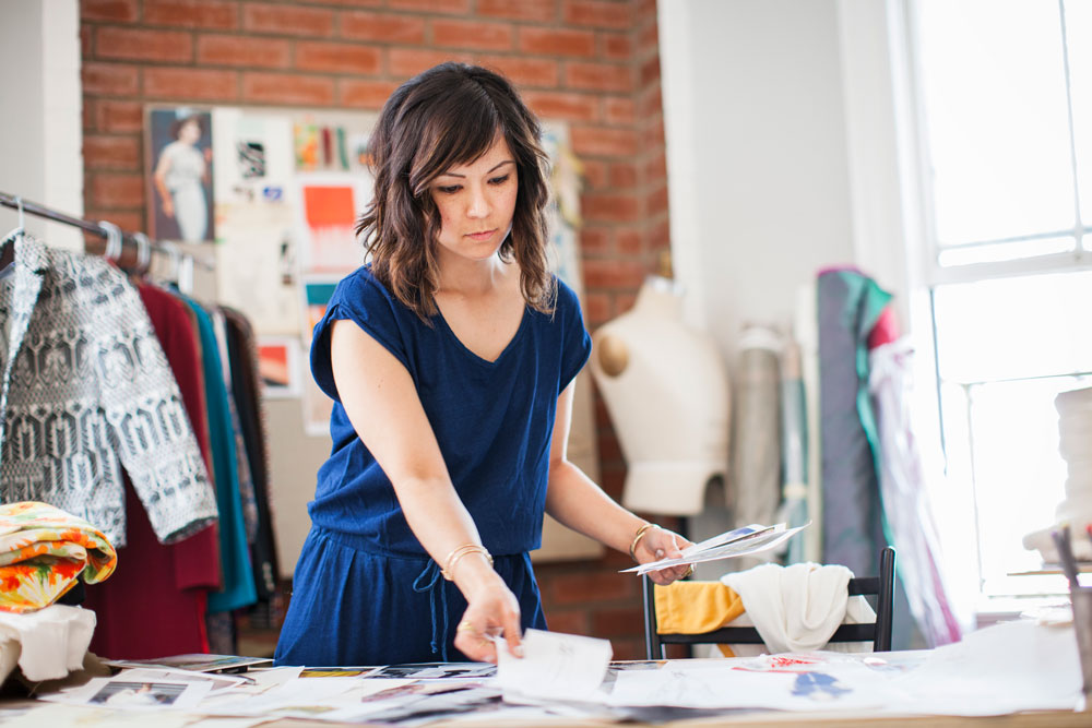 A woman sorting paper at work
