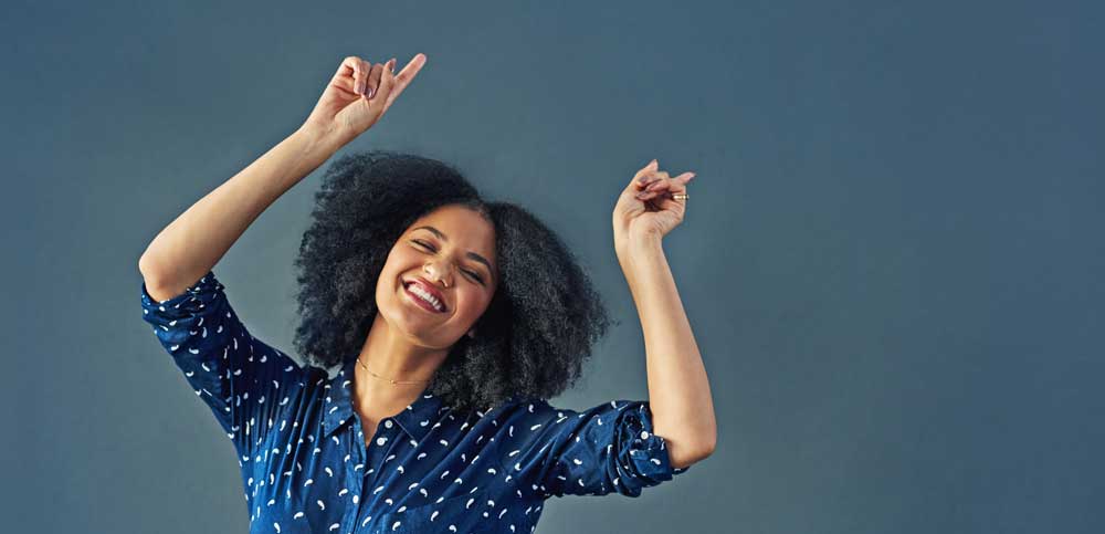 A woman celebrating her low monthly fees